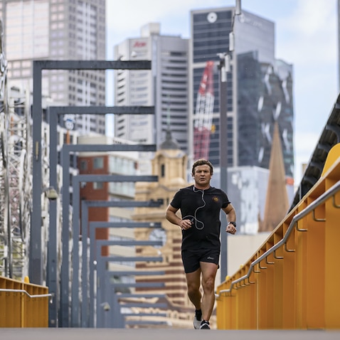 A man is seen exercising along a bridge in Southbank, Melbourne