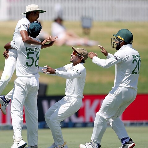 Bangladesh's Taijul Islam, celebrates catching Blackcaps Trent Boult during play on day five of the first cricket test between Bangladesh and New Zealand. 