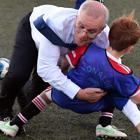 Prime Minister Scott Morrison accidentally tackled a child at the Devonport Strikers Soccer Ground on Day 38 of the 2022 federal election campaign in Devonport.
