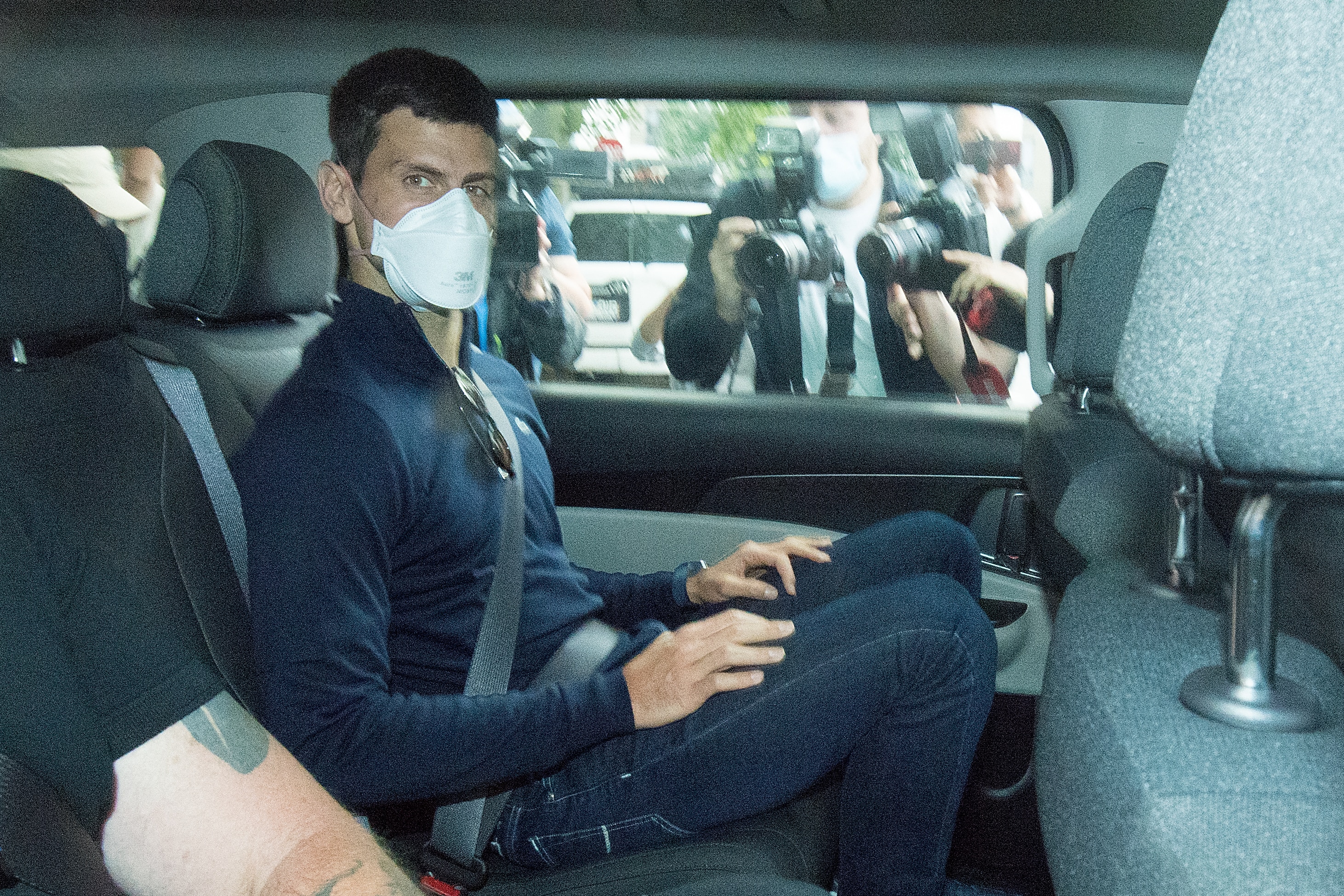 Djokovic departs from the Park Hotel government detention facility in Melbourne, Sunday, January 16, 2022. 
