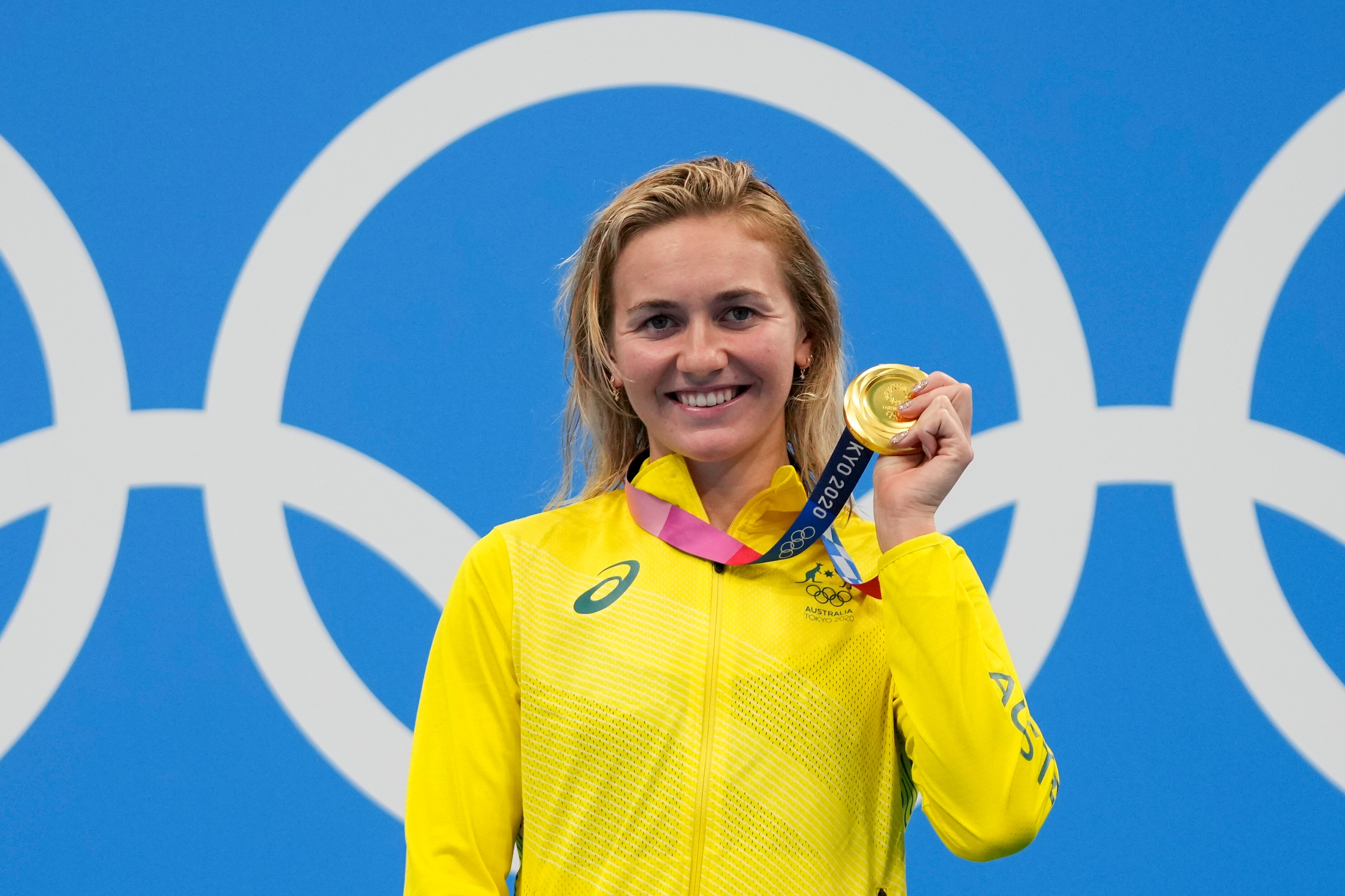Ariarne Titmus, of Australia holds up her medal after winning the final of the women's 400-meters freestyle at the 2020 Summer Olympics, Monday, July 26, 2021, in Tokyo, Japan. (AP Photo/Matthias Schrader)