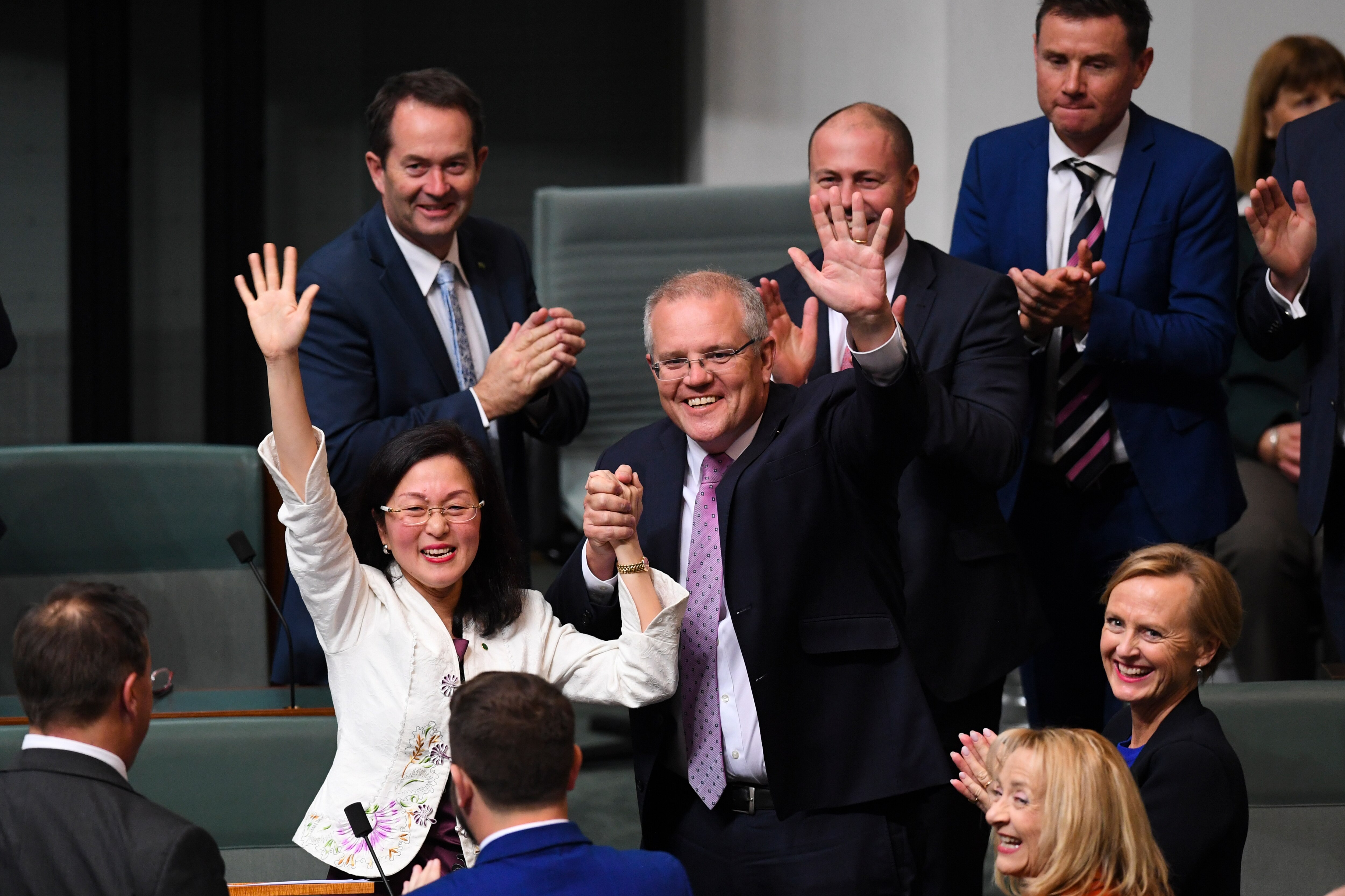 The Member for Chisholm Gladys Liu is congratulated by Australian Prime Minister Scott Morrison after delivering her maiden speech in the House of Representatives at Parliament House in Canberra, Tuesday, 23 July, 2019. (AAP Image/Lukas Coch) NO ARCHIVING