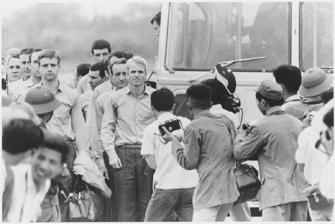 1973: Naval Aviator John McCain, centre, as he is being released with other prisoners of war from detention in North Vietnam.