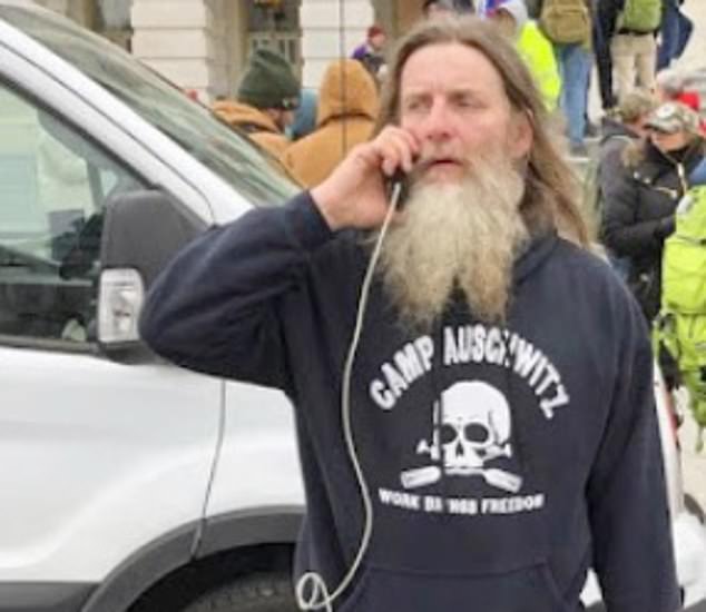 A protester at the US Capitol riots wearing a 'Camp Auschwitz' jumper.