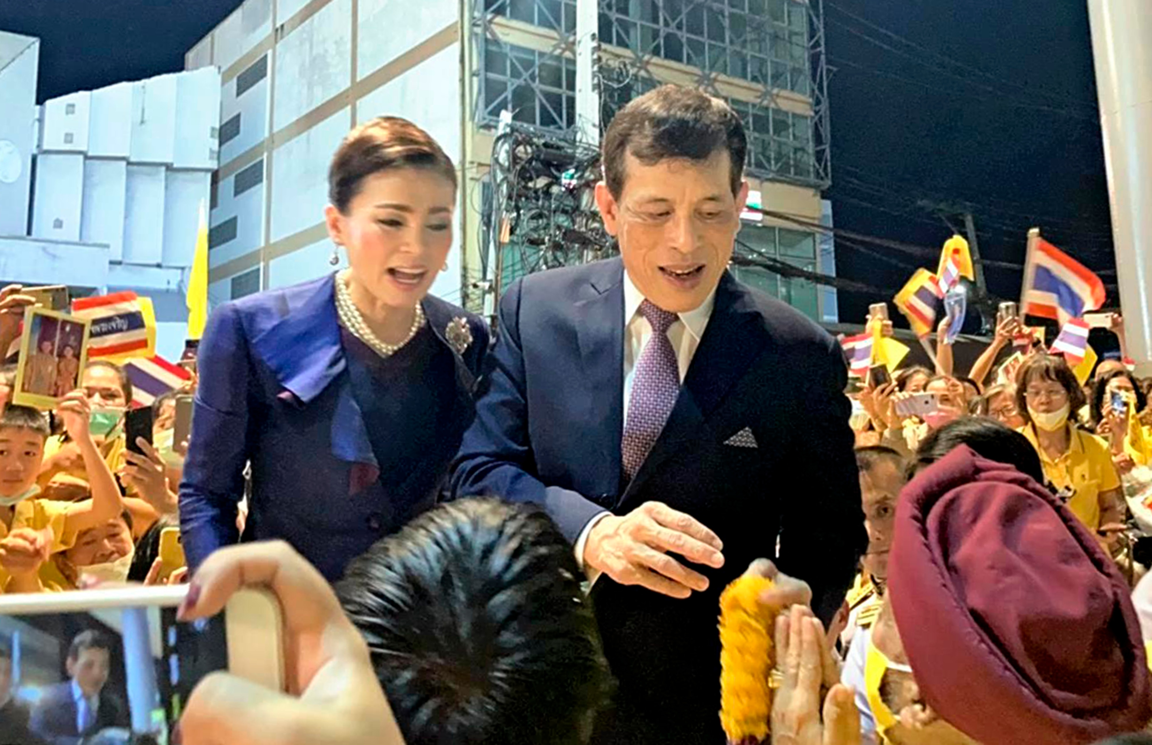 Thai King Maha Vajiralongkorn accompanied by Queen Suthida talks to supporters after attending the opening ceremony of a station in Bangkok, Thailand on Nov. 14, 2020. ( The Yomiuri Shimbun via AP Images )