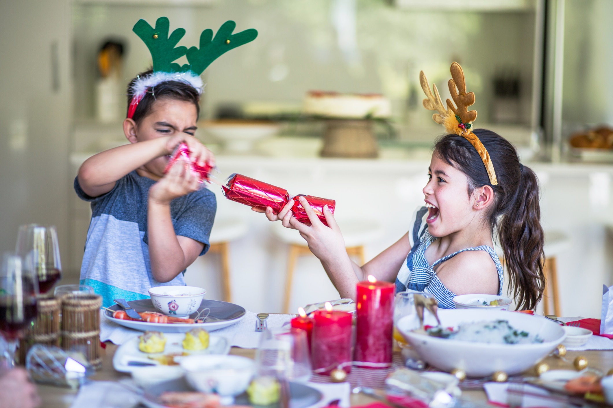 Australian children at home pulling christmas cracker at table