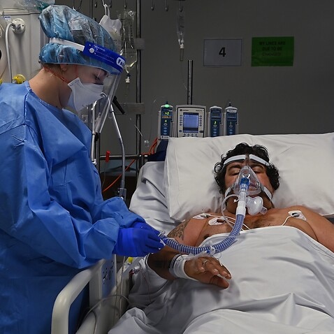 A supplied image of ICU Registered Nurse Shaunagh Whelan (left) caring for a COVID-19 positive patient in the ICU of St Vincent's Hospital in Sydney. (file)