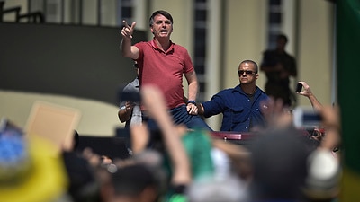 Jair Bolsonaro joins hundreds of anti-lockdown protesters in Brazil