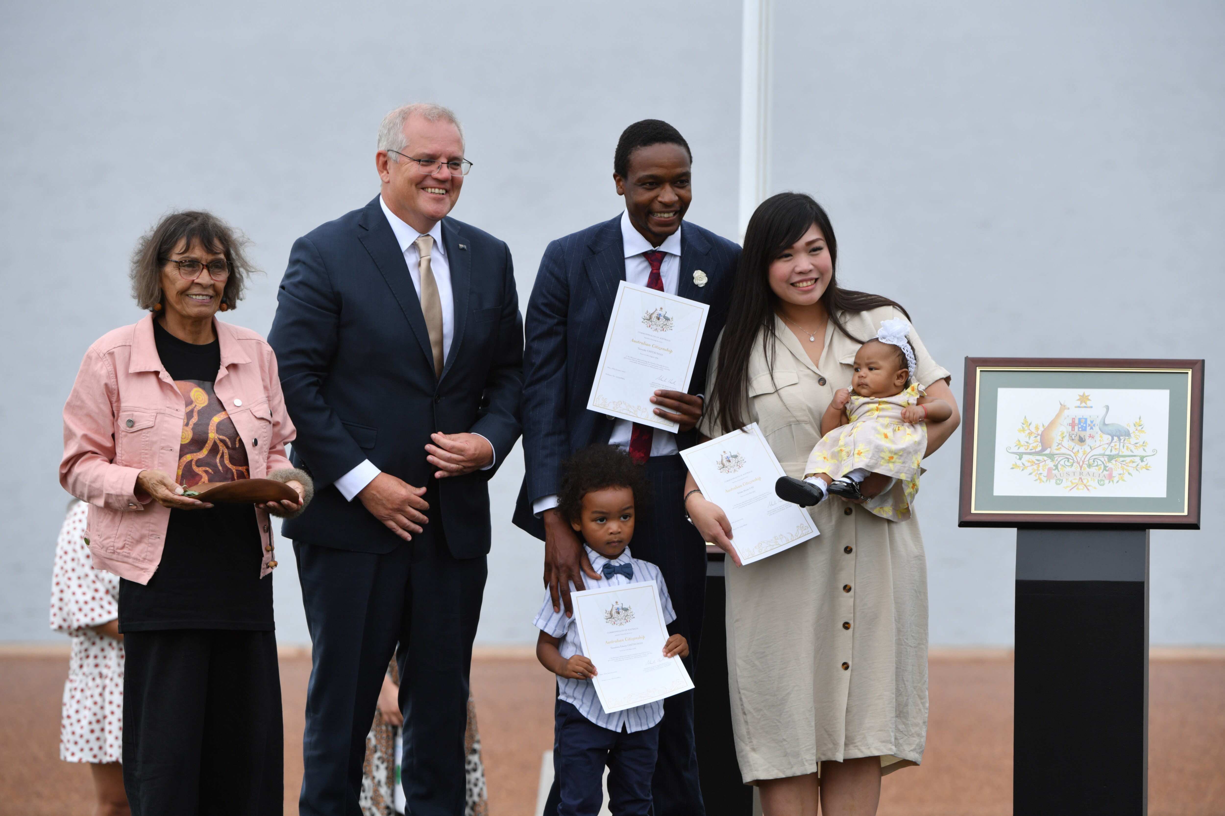 Prime Minister Scott Morrison poses for photos with new citizens Tatenda Chitsungo (third from left), wife Eliska Sy and their children.