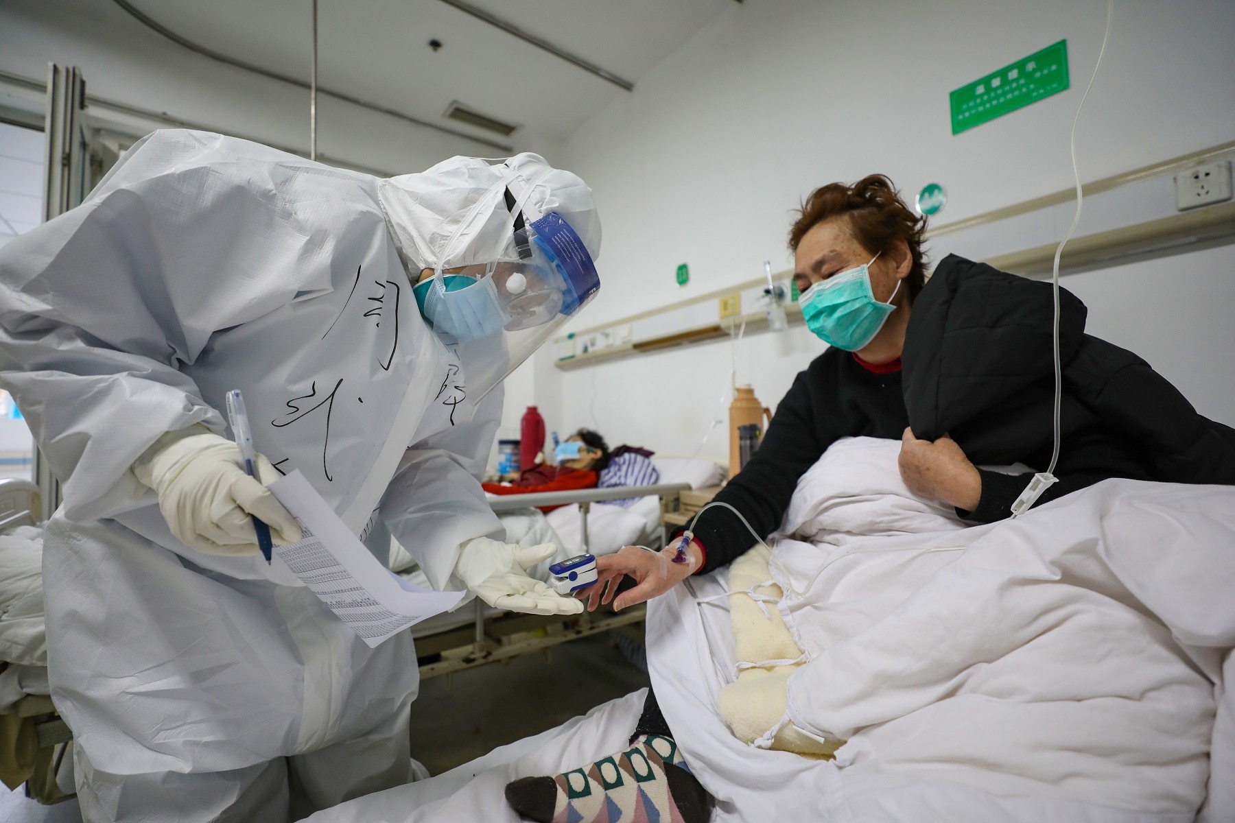 A doctor checks oxygen saturation of a patient at Jinyintan Hospital, in Wuhan, Hubei province, China. A doctor checks oxygen saturation of a patient at Jinyintan Hospital, in Wuhan, Hubei province, China.