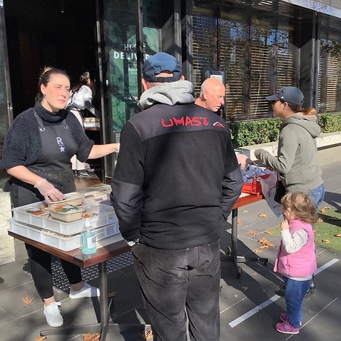 Deborah Monrad-Hunt distributing meals outside Rockpool Bar and Grill in Melbourne
