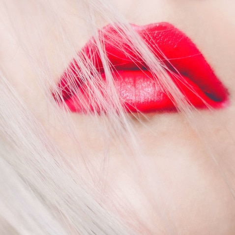 Image of an unidentifiable woman with red lips.