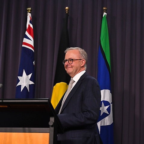 The Australian flag, the Aboriginal flag and the flag of the Torres Straits Islands are seen behind Australian Prime Minister Anthony Albanese during his press conference at Parliament House in Canberra, Monday, May 23, 2022. (AAP Image/Lukas Coch) NO ARC