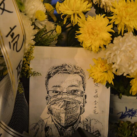 A card with a portrait of Li Wenliang outside a hospital in Wuhan in central China's Hubei province, 7 February 2020