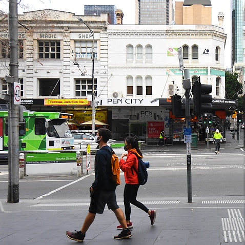 People are seen wearing face masks in the central business district in Melbourne.                  