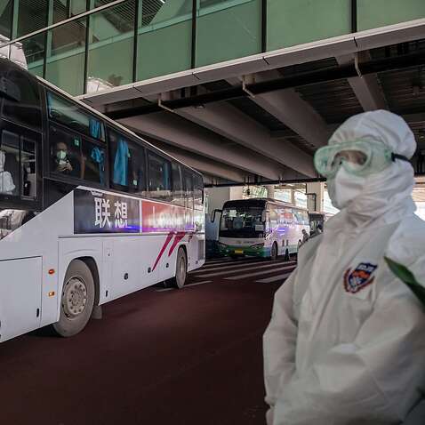 A bus carrying members of the WHO team leaves the airport following their arrival in Wuhan on 14 January. 