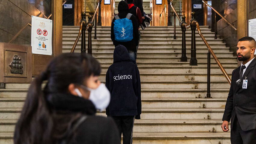 International students line up for food vouchers outside the Melbourne Town Hall.