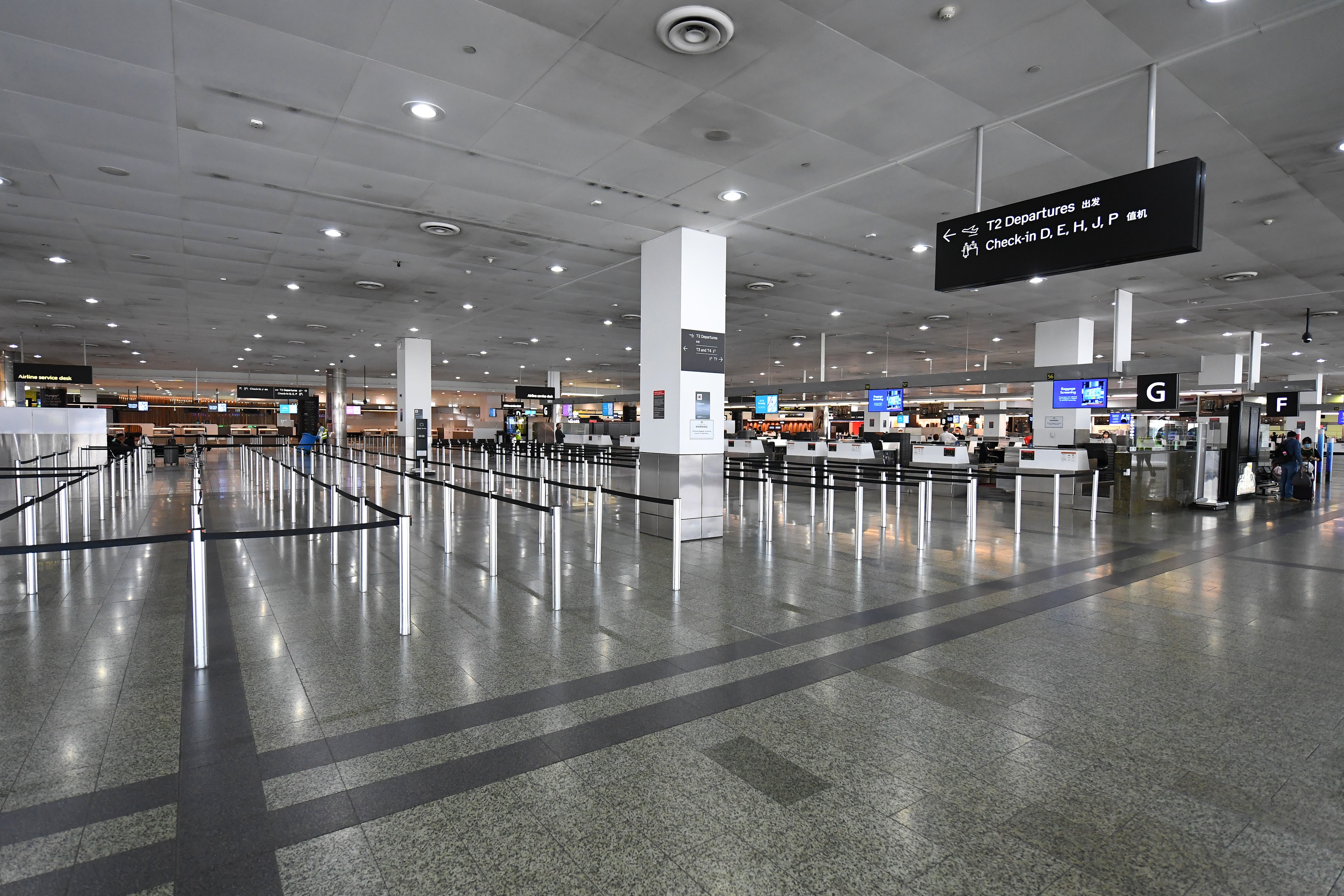 General view of empty baggage check-in lines inside in International terminal at Tullamarine Airport, Melbourne, Friday, March 13, 2020. (AAP Image/James Ross) NO ARCHIVING