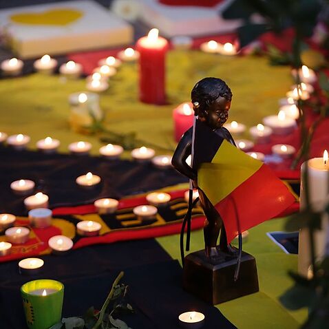 A miniature sculpture of Brussels' landmark Manneken Pis is seen in tribute to victims at a makeshift memorial in front of the stock exchange in Brussels 
