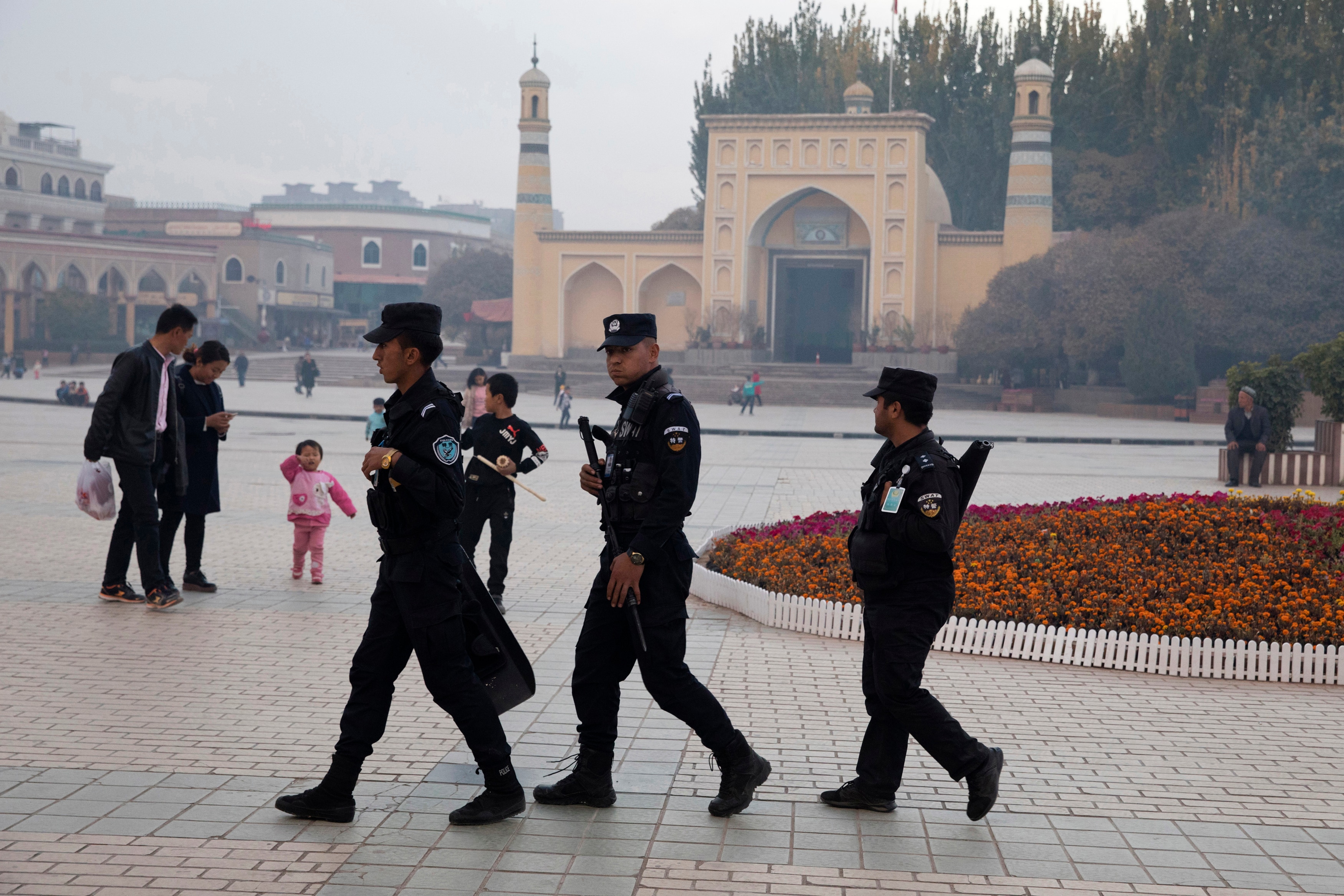 Uighur security personnel patrol near the Id Kah Mosque in Kashgar in western China's Xinjiang region.