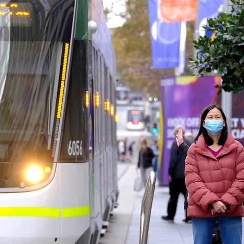 A commuter is seen wearing a face mask while using public transport in Melbourne, Monday, May 24, 2021. 