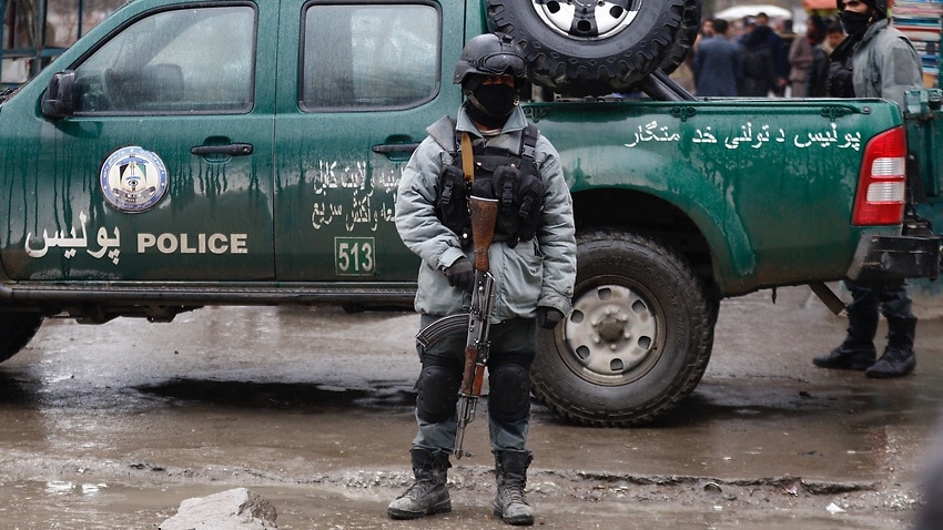 Afghan security officers secure the area of an explosion in Kabul.