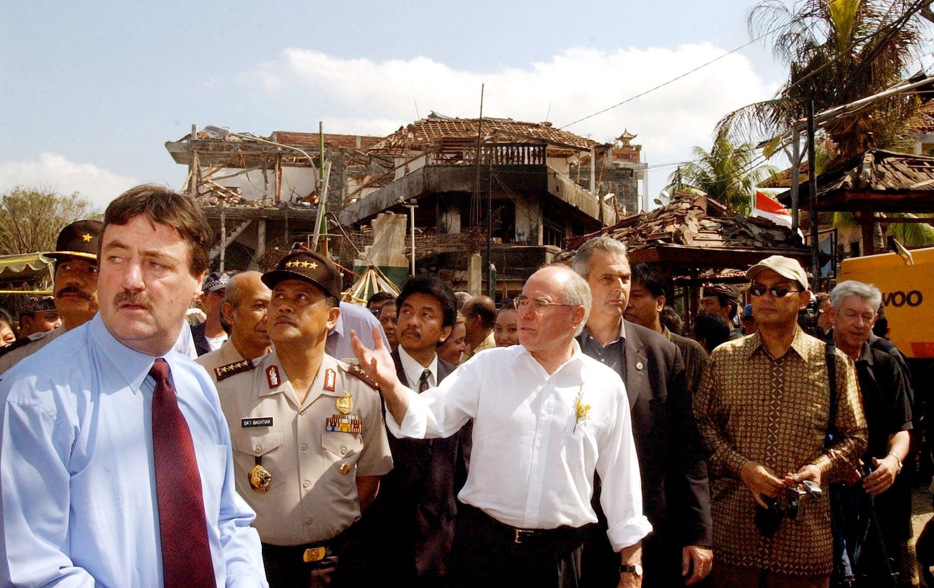 Australian Prime Minister John Howard (centre) tours the site of the bombings in 2002