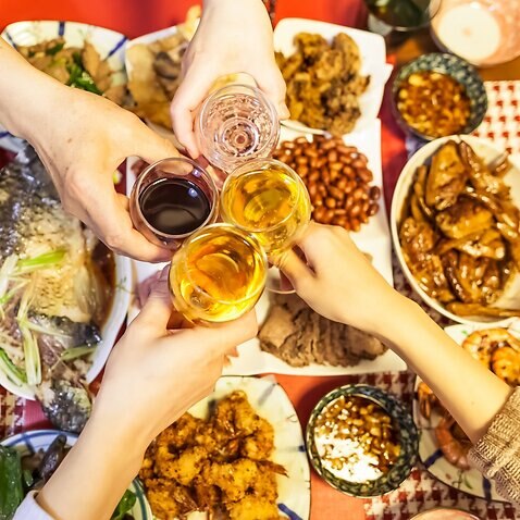 Family are toasting beers and wines over Chinese traditional dishes celebrating for Chinese new year, Tokyo, Japan.