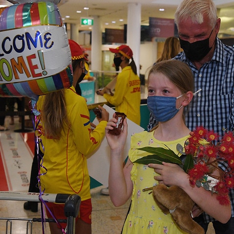 Charlotte Roempke welcomes her grand father Bernie Edmonds as he arrives at Sydney International Airport