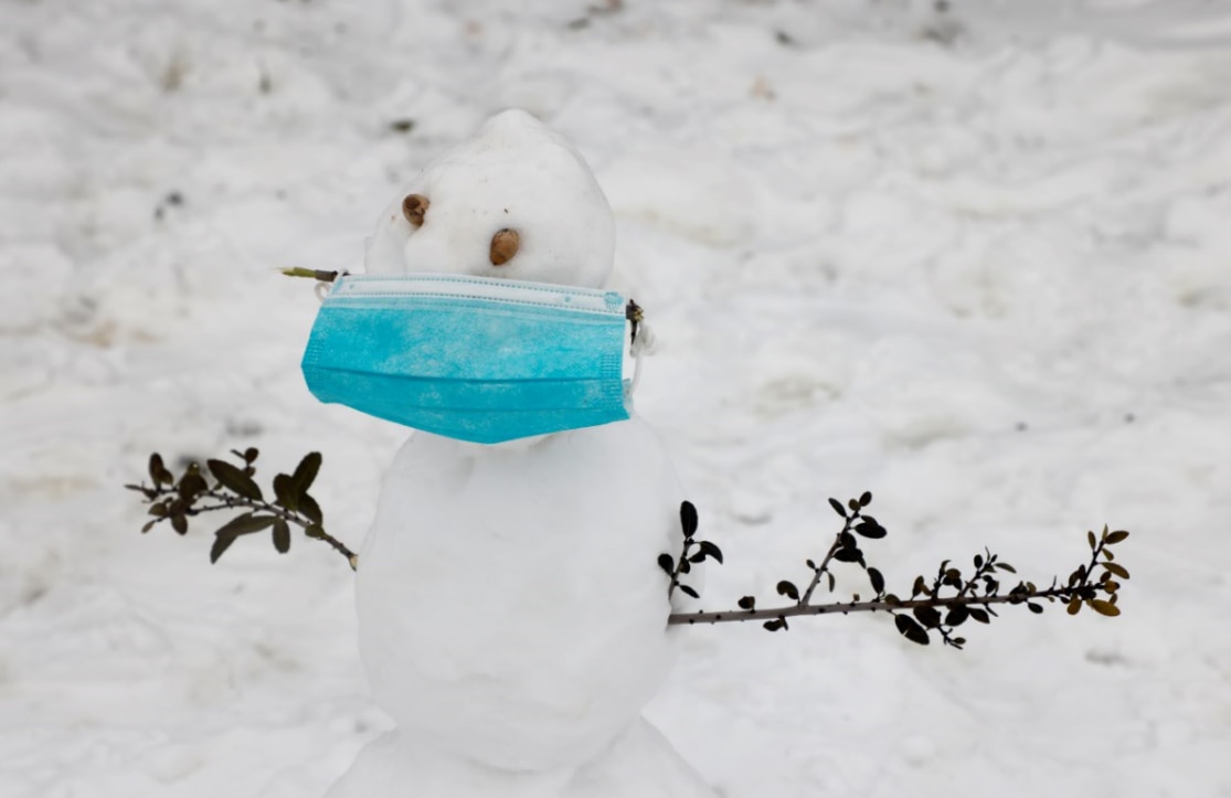 A mask-covered snowman created in front of a home in Euless, Texas, Thursday, February 18, 2021