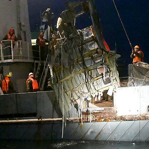 Ministry employees lift a fragment of a plane in the Black Sea, outside Sochi, Russia. 