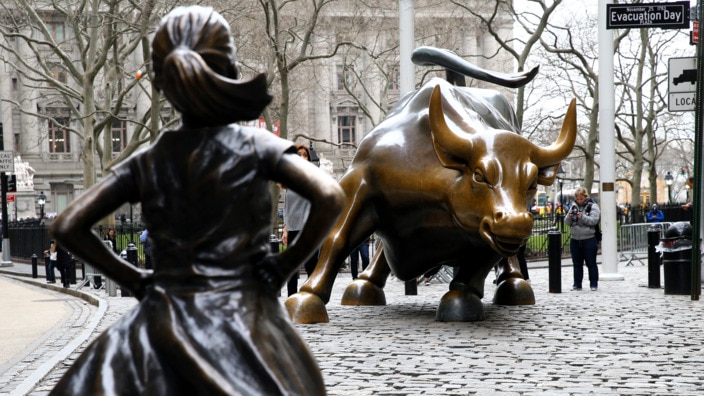 The "Fearless Girl" statue, a four-foot statue of a young girl, defiantly looks up the iconic Wall Street "Charging Bull" sculpture in New York City, United States on March 29, 2017.