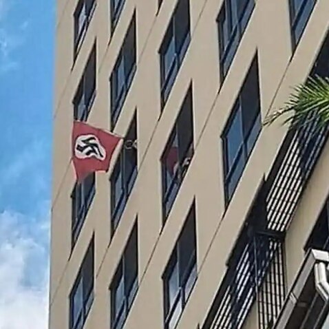 Police have seized a Nazi flag that was flown from an apartment window near a Brisbane synagogue
