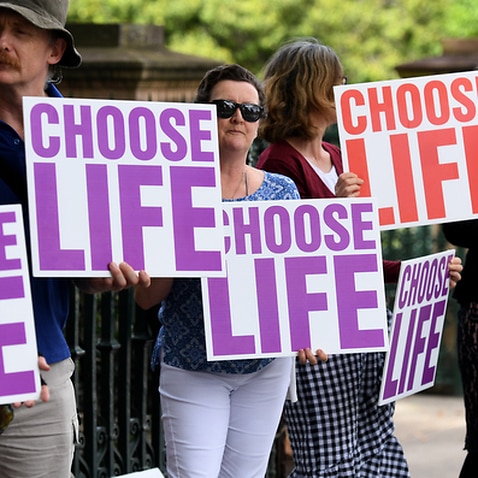 Anti-abortion protesters outside Queensland Parliament House as MPs debate laws to decriminalise abortion in the state 