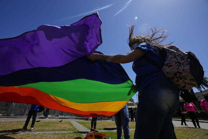 Members of the Movement for Homosexual Integration and Liberation place a LGBT rainbow flag in front of the National Congress, in Valparaiso, 30 November, 2021.