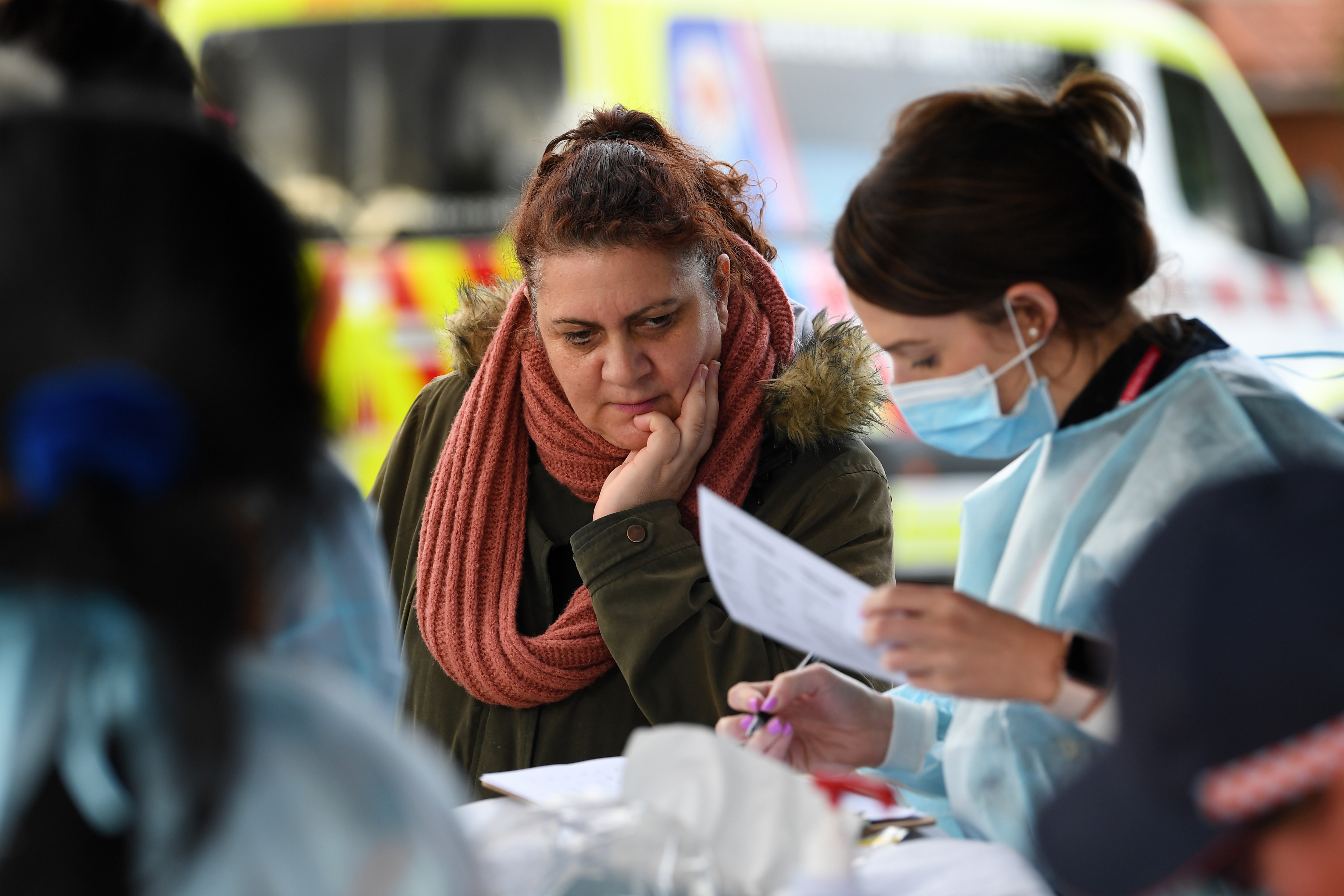 People wait in line to receive a COVID-19 test at a Coronavirus pop-up testing facility in Broadmeadows, Melbourne.