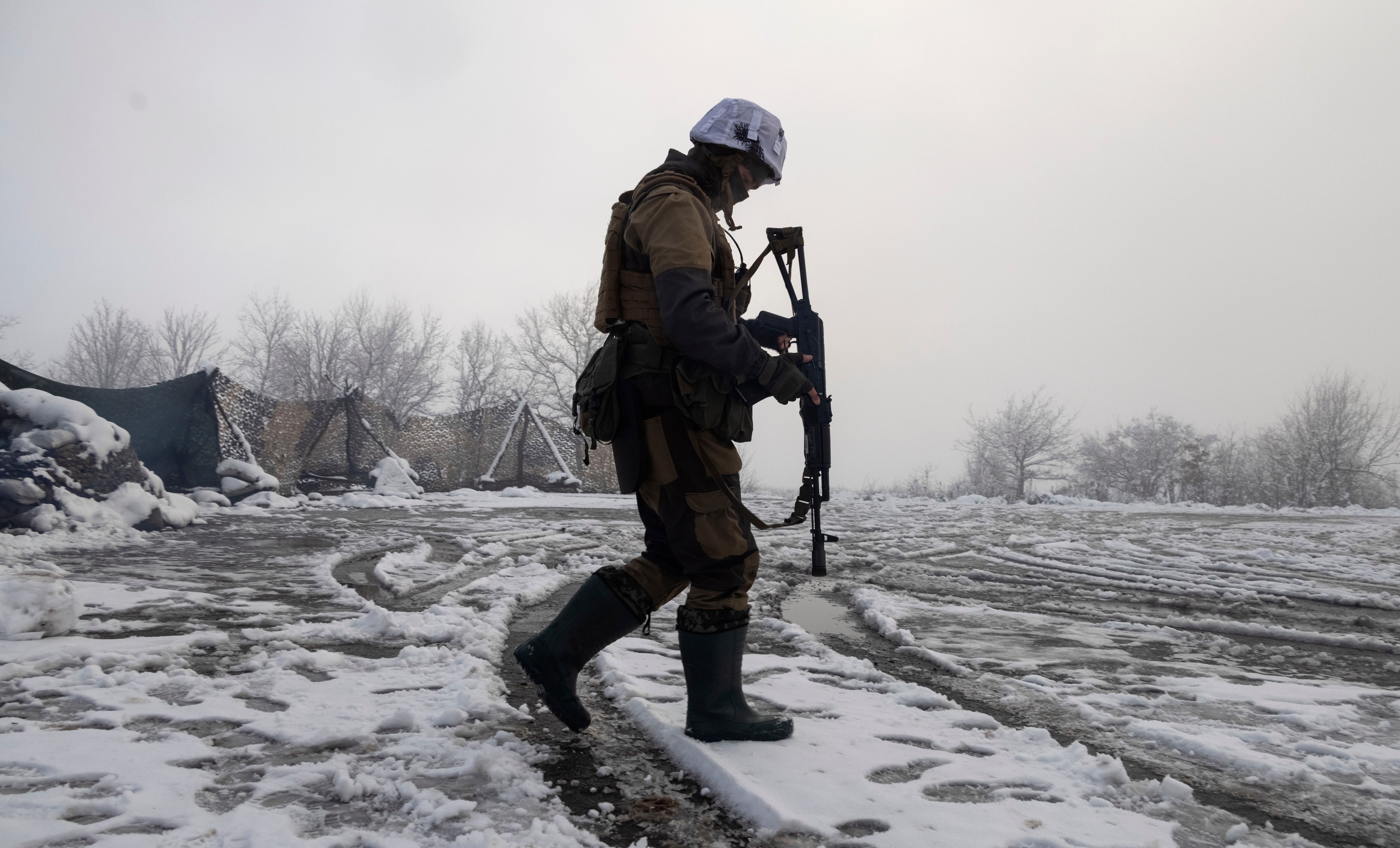 A Ukrainian soldier walks at the dividing line from pro-Russian rebels near Popasna in the Donetsk region, Ukraine