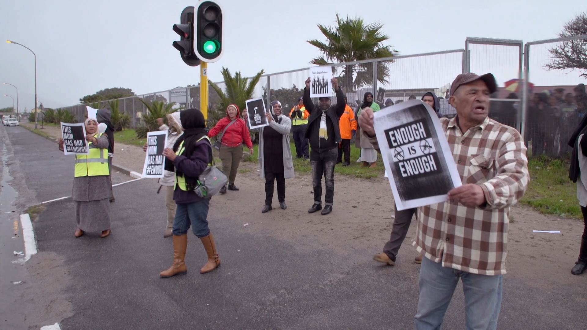 Parents protest violence outside the local school. Parents protest violence outside the local school.