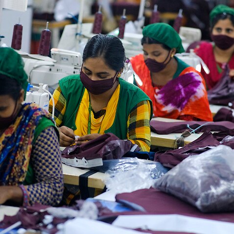Employees work in a sewing section of the Snowtex Sportswear Ltd in Savar, Bangladesh.