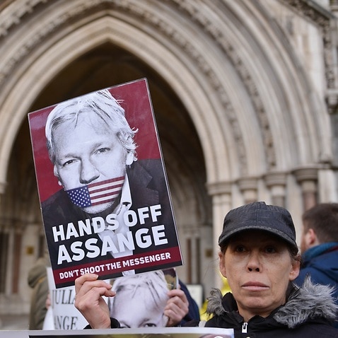 A protester seen with a placard expressing her opinion at the Royal Courts of Justice.U.S wins appeal to extradite Wikileaks founder Julian Assange from the UK. (Photo by Thomas Krych / SOPA Images/Sipa USA)
