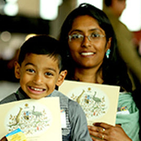 A family receiving their Australian citizenship certificate.