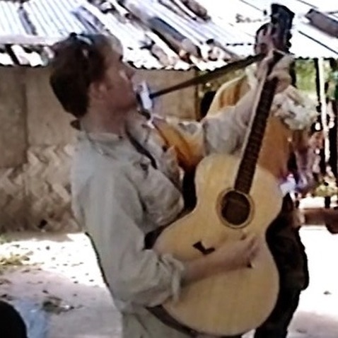 Image of a member on peacekeeping missions to Bougainville playing guitar.