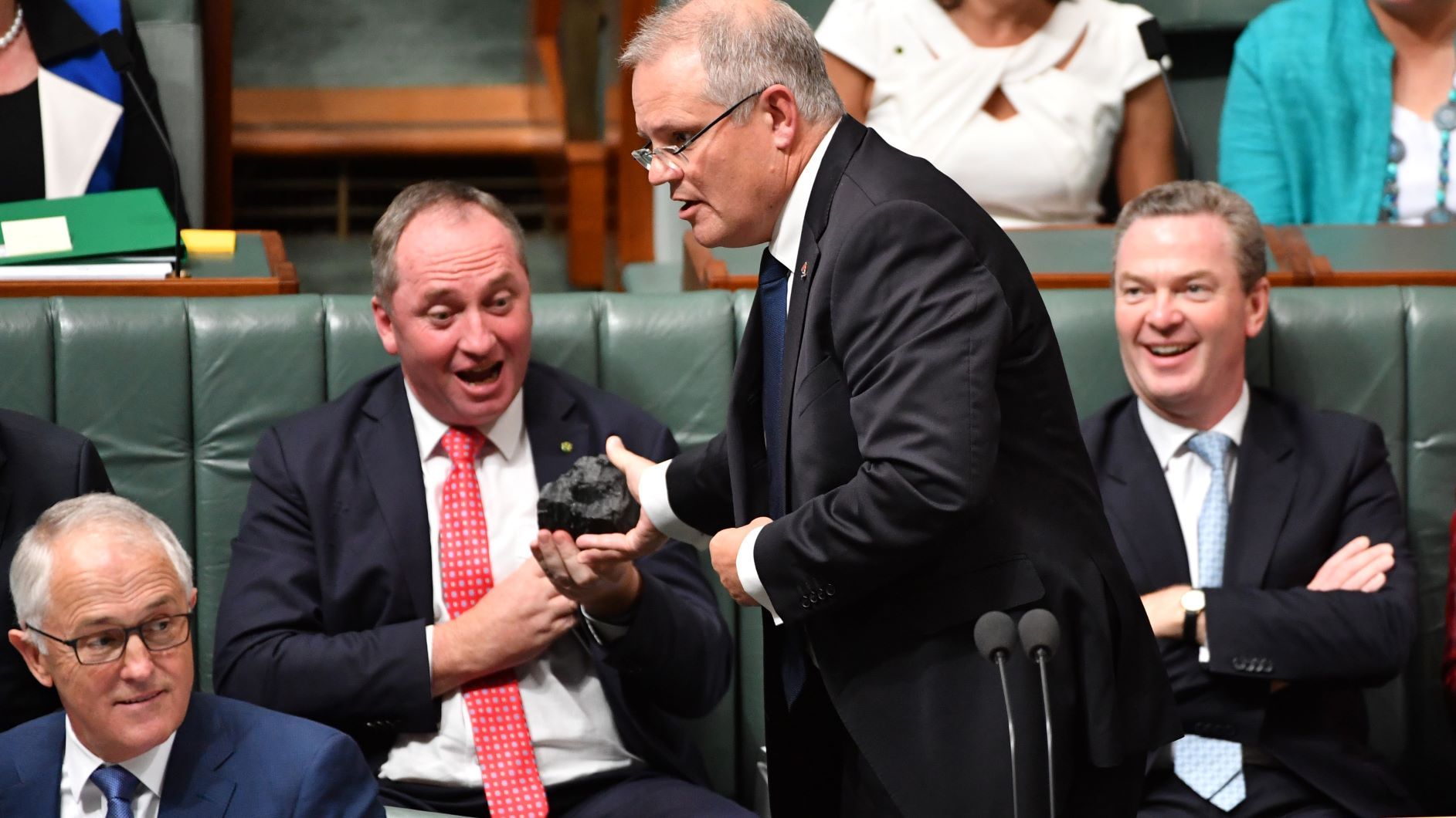 Treasurer Scott Morrison hands Deputy Prime Minister Barnaby Joyce a lump of coal during Question Time at Parliament House 
