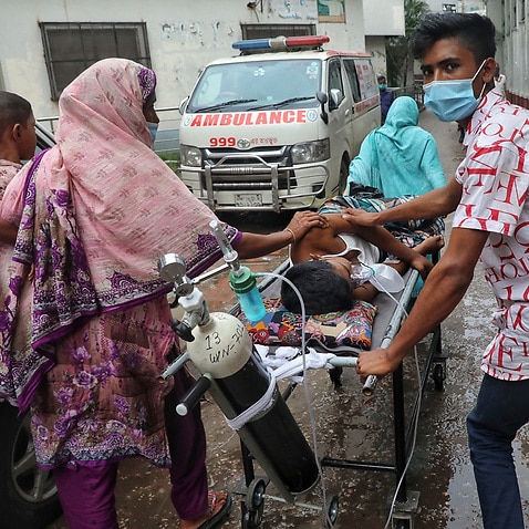 DHAKA, BANGLADESH - AUGUST 3: A patient is transport in ambulance to Dhaka Medical Hospital, to health workers treats the patient in the intensive care unit.