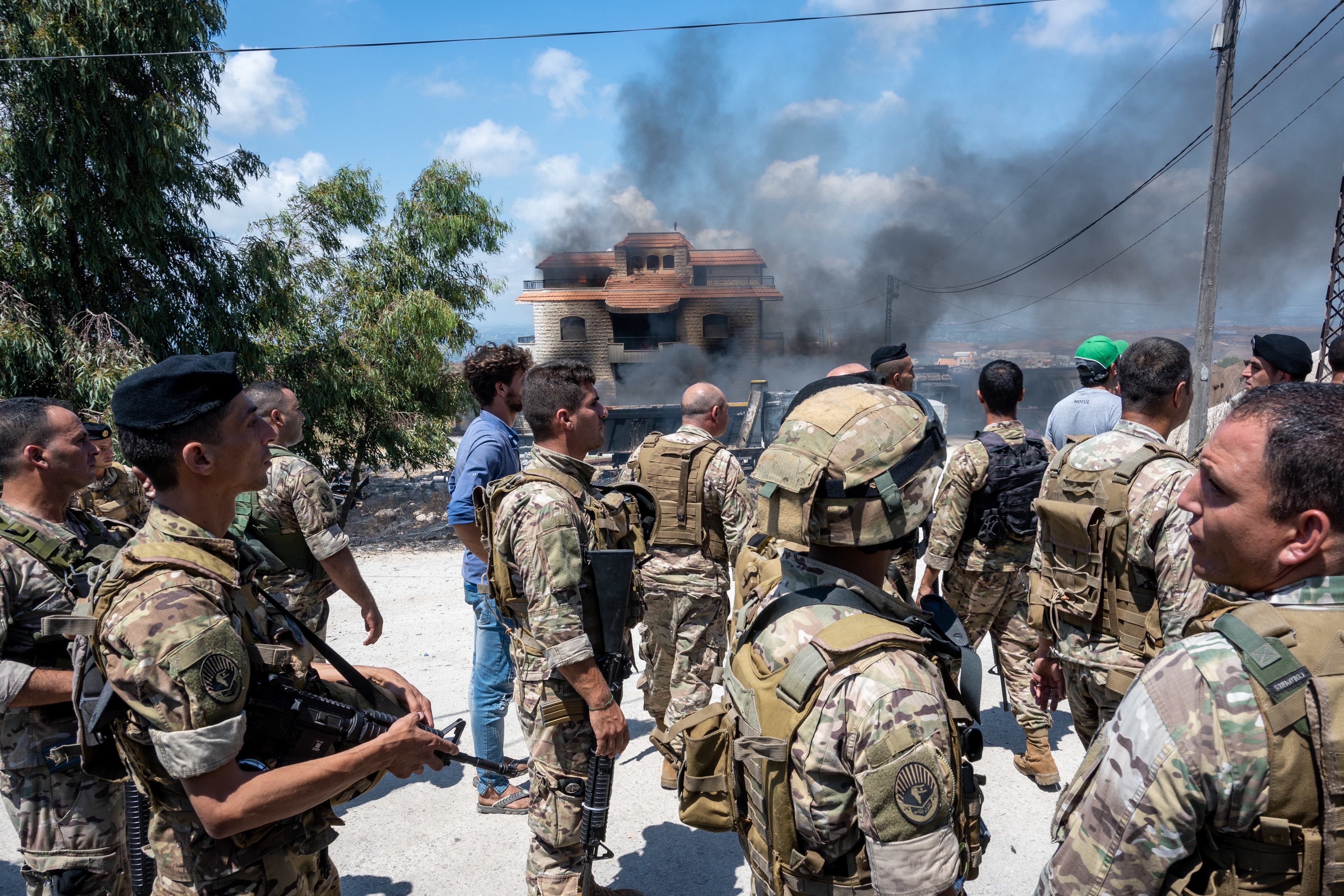 A crowd outside the house of trafficker family where a fuel tank exploded in the village of Tiel, in Akkar area, northern Lebanon, on August 15, 2021