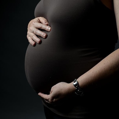 A pregnant woman.