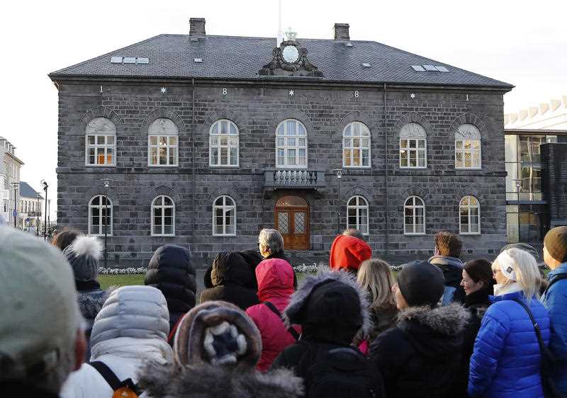 File photo of people looking at the Icelandic parliament the Althing in Reykjavik. 