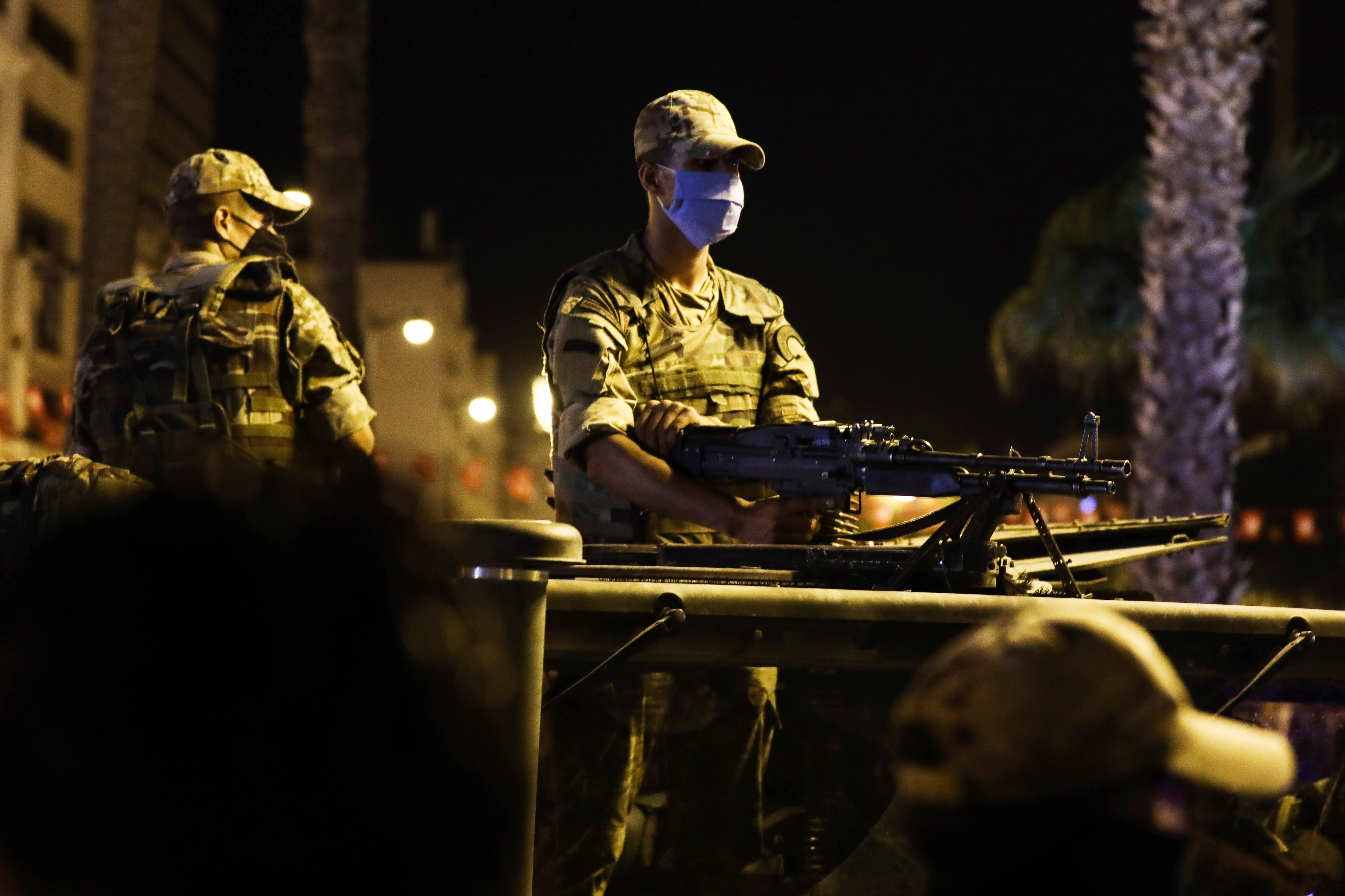 Soldiers stand by as supporters of Tunisia's President Kais Saied gather on the streets