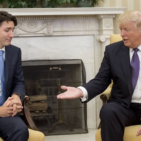 FILE: US President Donald Trump and Canadian Prime Minister Justin Trudeau shake hands during a meeting in the Oval Office.