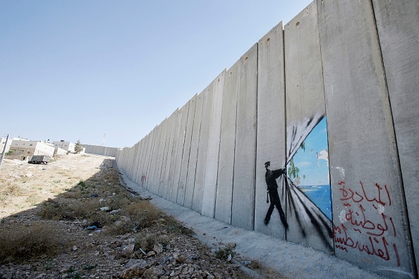 Banksy art on Israel's highly controversial West Bank barrier in Abu Dis in 2005. Banksy has made a name for himself with provoc